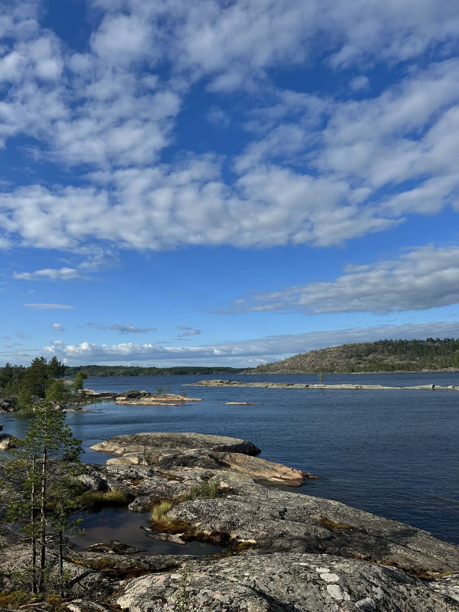 Rocky Ladoga coast beneath a bright blue summer sky