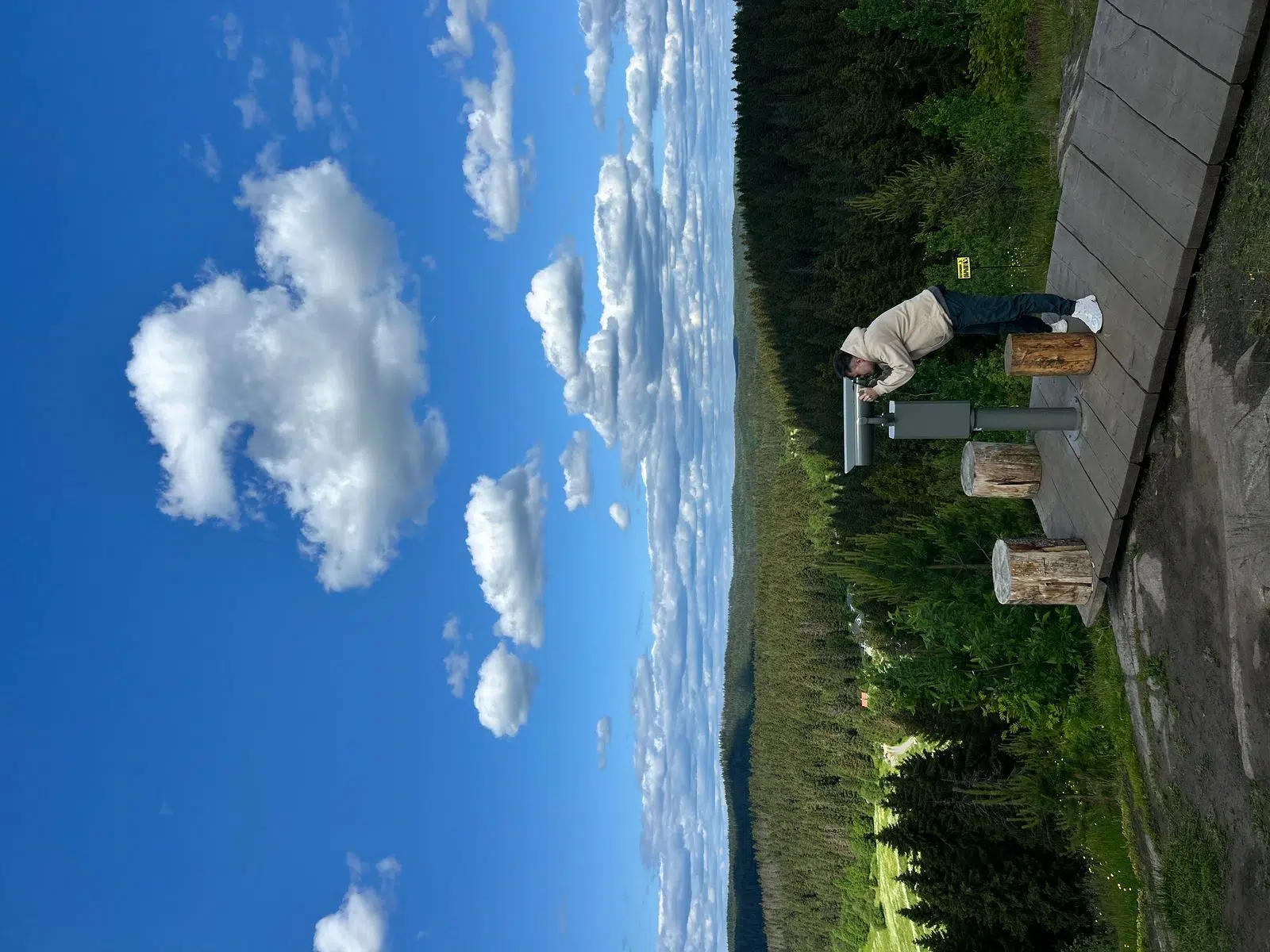 Traveler at a hilltop viewpoint overlooking Karelia's forests and lakes