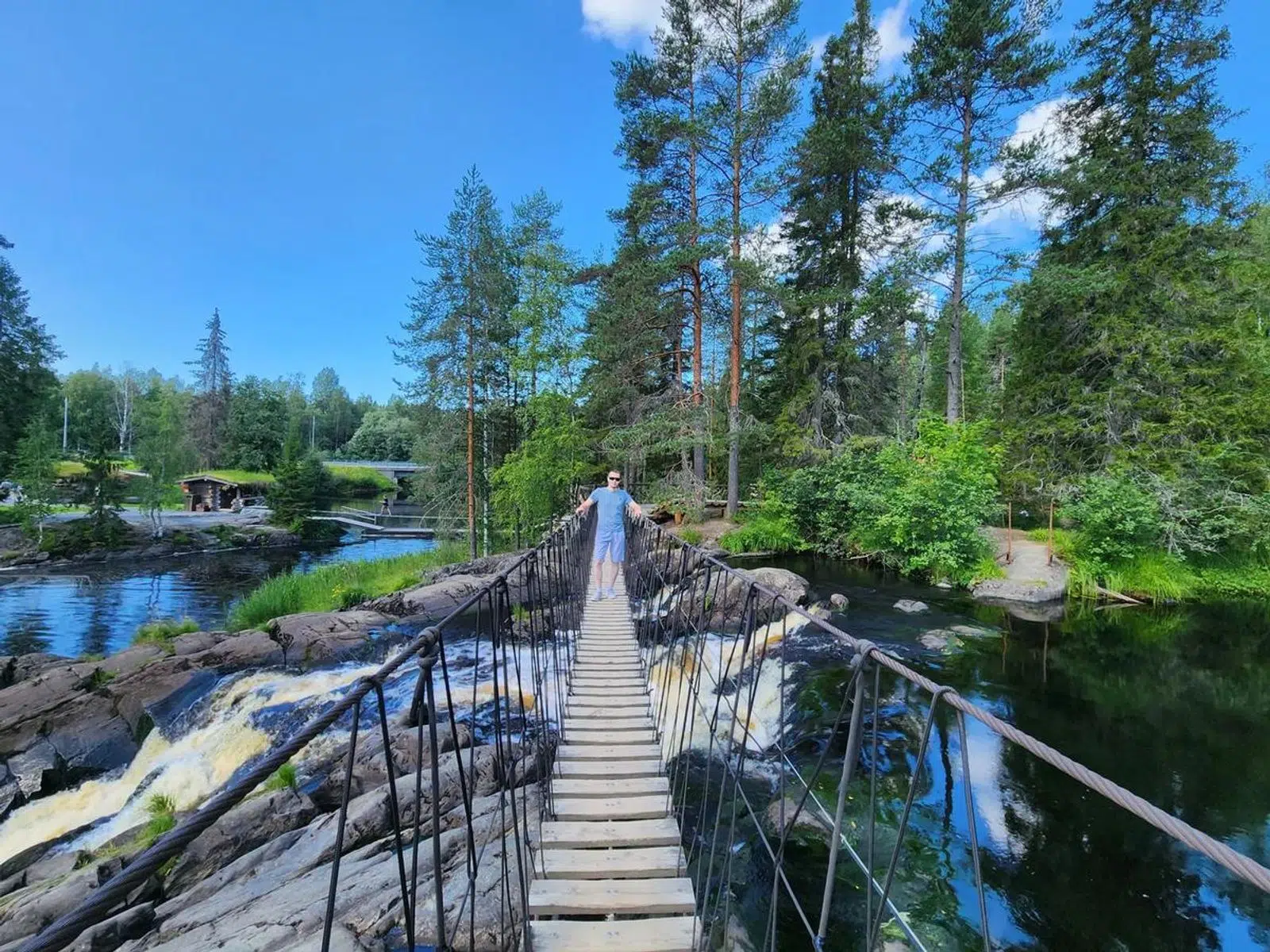 Suspension footbridge crossing a rocky stream in the forest