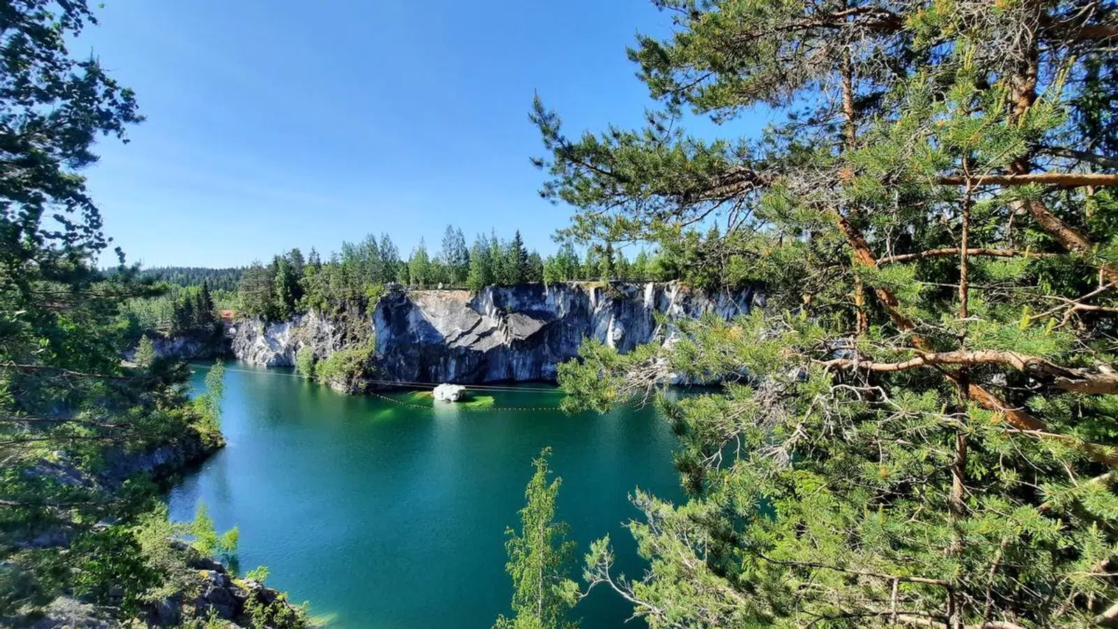 Turquoise water filling Ruskeala's forested marble canyon