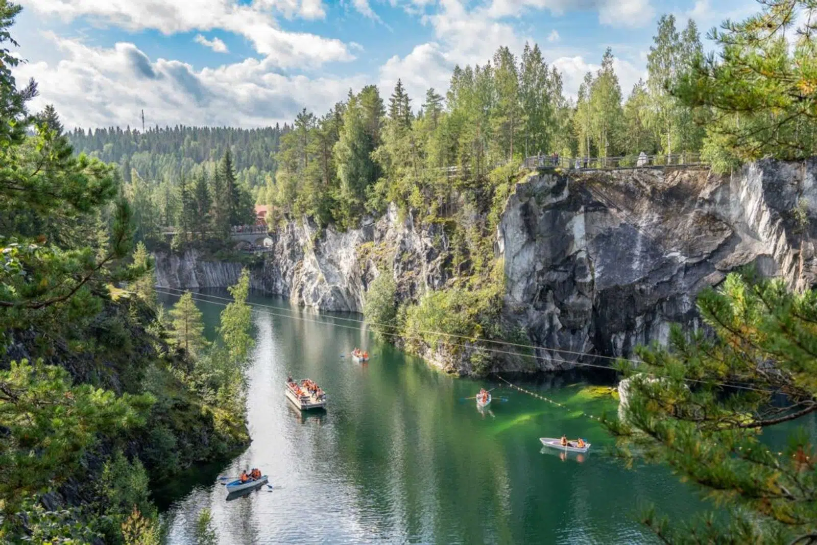 Boats on the green water of Ruskeala Marble Canyon