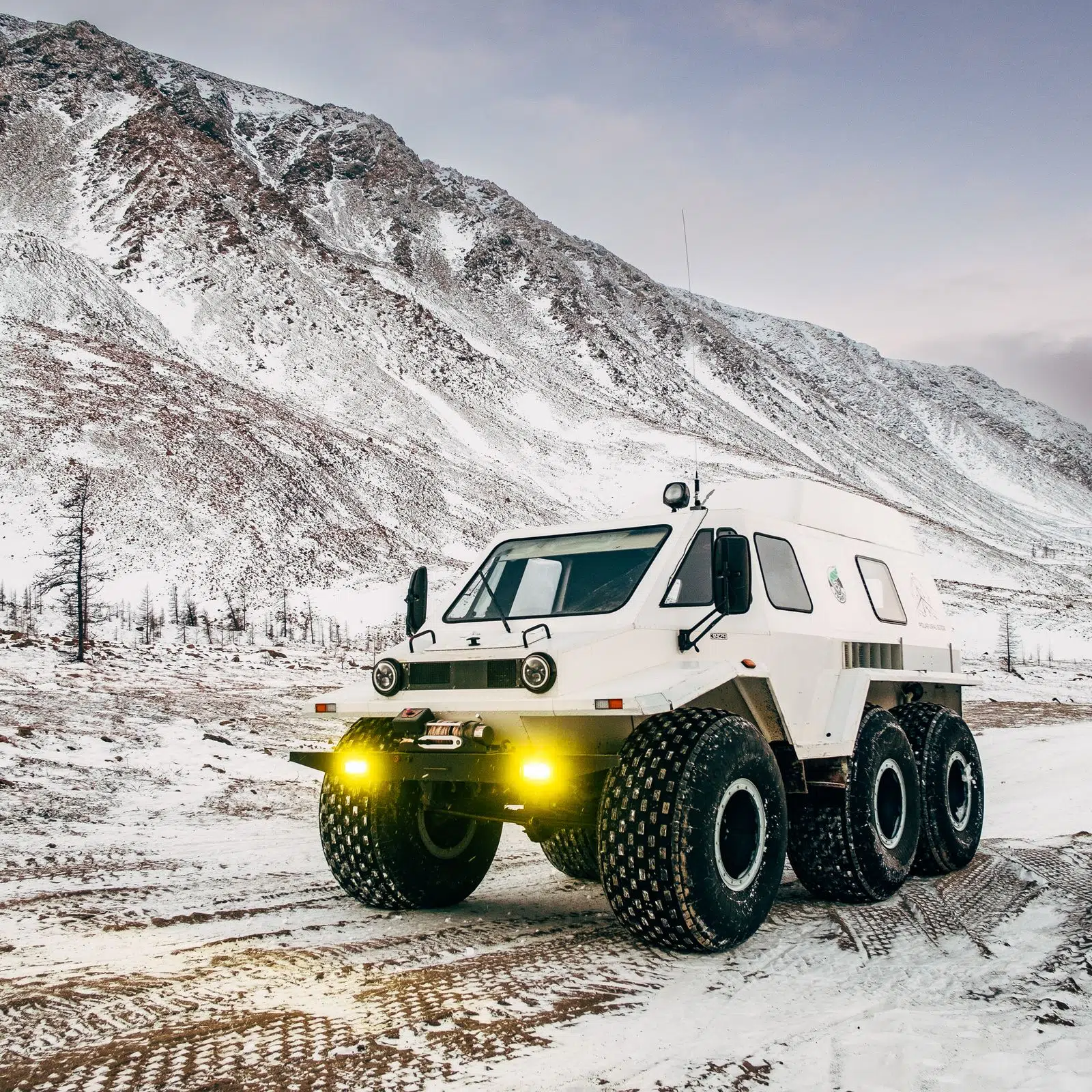 Large-wheeled Arctic all-terrain vehicle on a snowy mountain road
