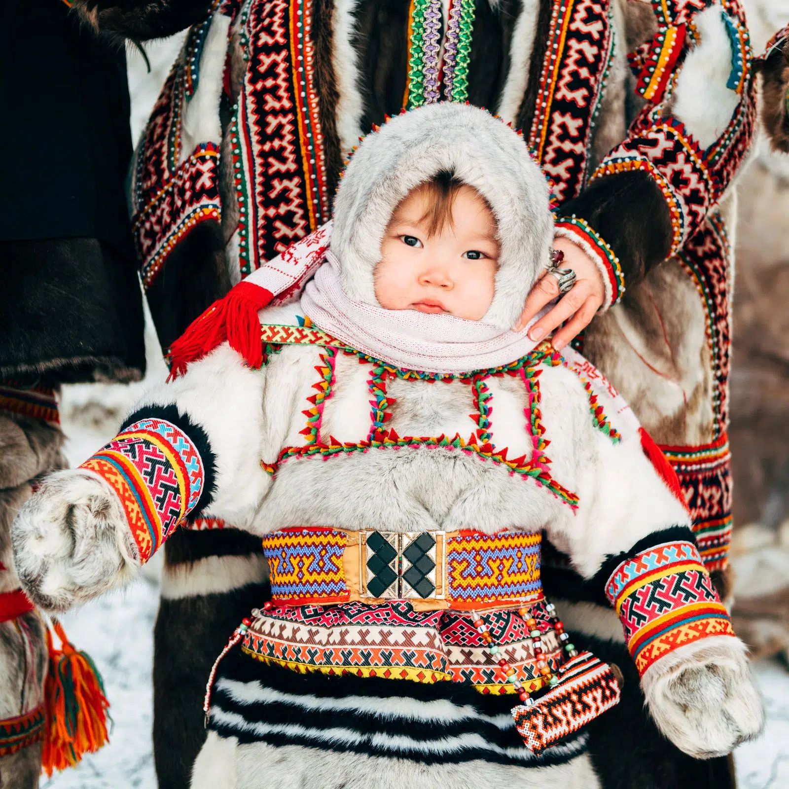 Nenets child dressed in brightly embroidered traditional winter clothing
