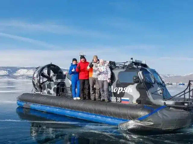 Travelers beside a hovercraft on the frozen lake