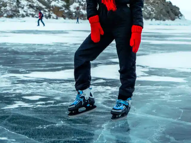 A traveler ice skating on Lake Baikal