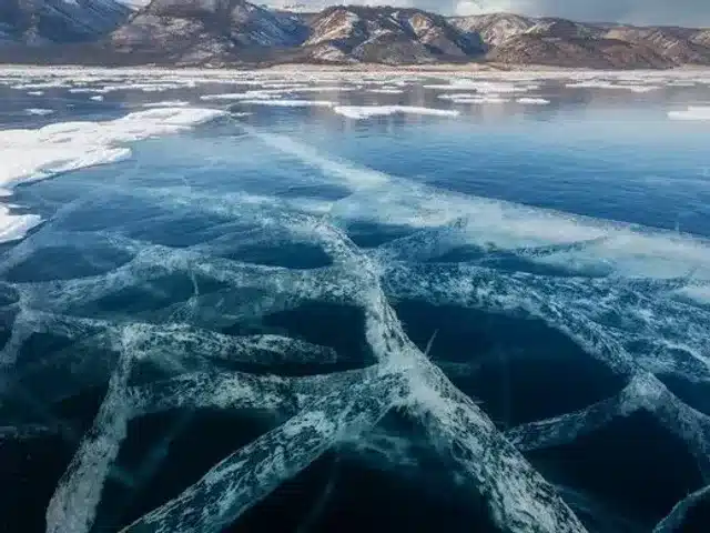 Clear blue Baikal ice crossed by broad white cracks