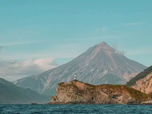 A volcanic peak and rocky island seen from the Pacific